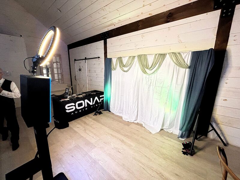 A Sonar Audio Visual booth facade with draping and a ring light