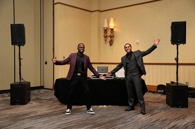 Two Sonar Audio Visual crew either side of a DJ booth with speakers